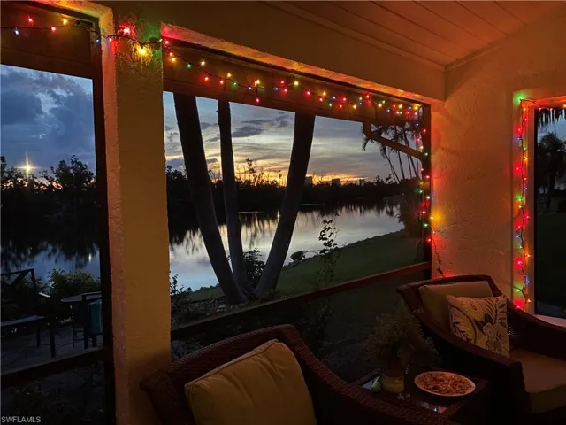 Sunroom / solarium featuring a water view