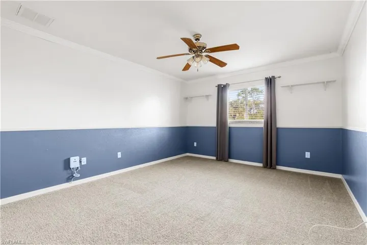 Unfurnished room with carpet, ceiling fan, and ornamental molding