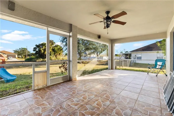 Unfurnished sunroom with ceiling fan and plenty of natural light