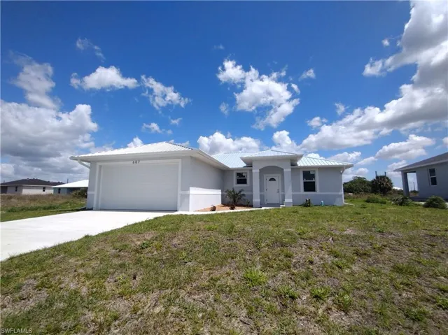 Ranch-style house with a garage and a front lawn