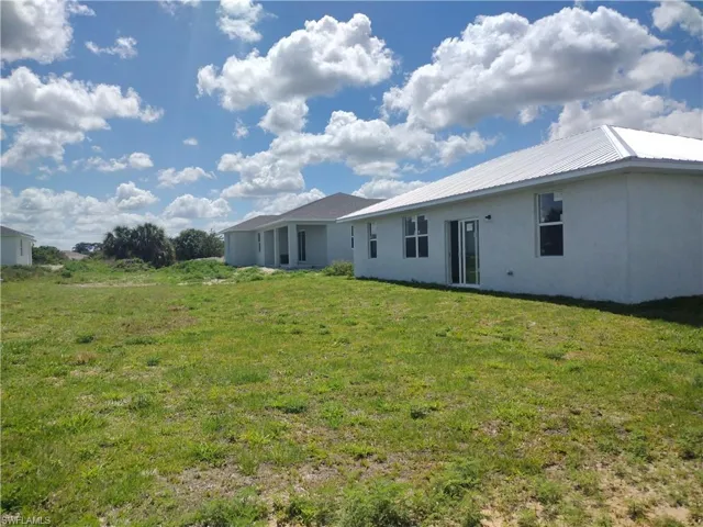 Rear view of house with a yard