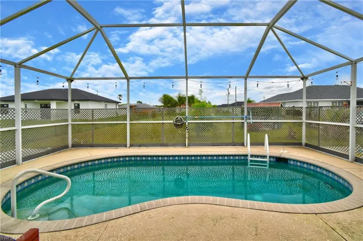 View of pool featuring a fenced in pool, glass enclosure, a patio, and fence