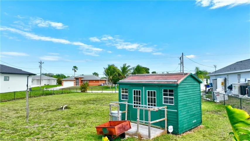 View of shed featuring fence