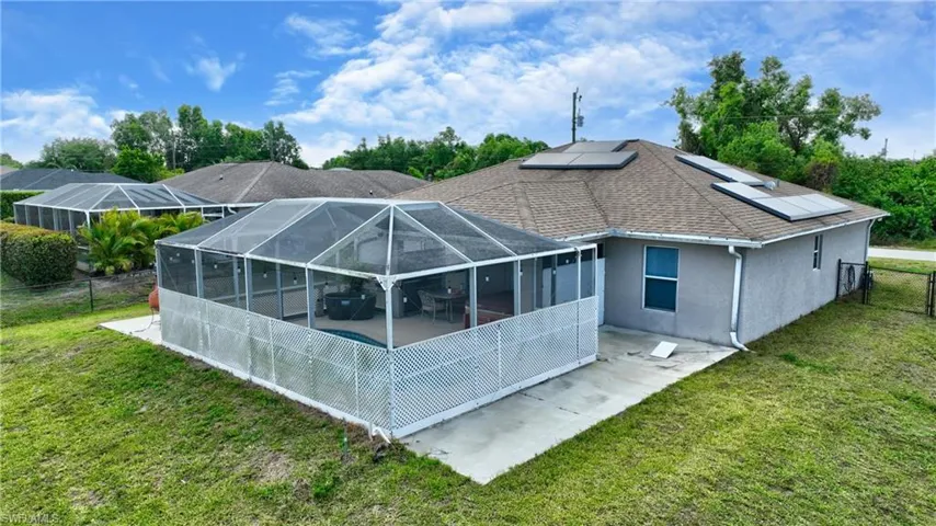 Rear view of property with a patio, a yard, a fenced backyard, and stucco siding