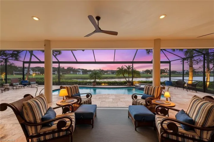 Screened lanai featuring a swimming pool, integrated spa, and paver decking