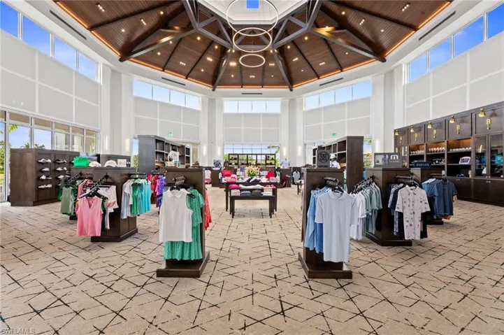 Grand interior space featuring a soaring wood-paneled ceiling with recessed lighting