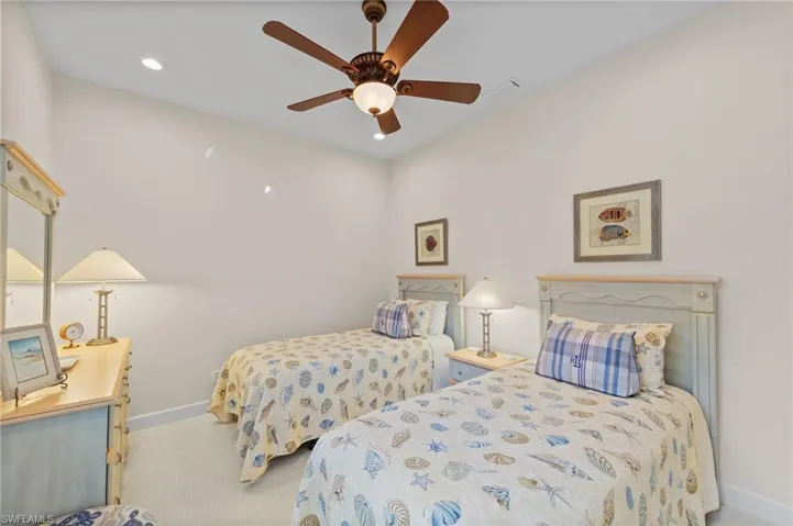 Carpeted room featuring a ceiling fan with integrated lighting, recessed lighting, and white baseboards