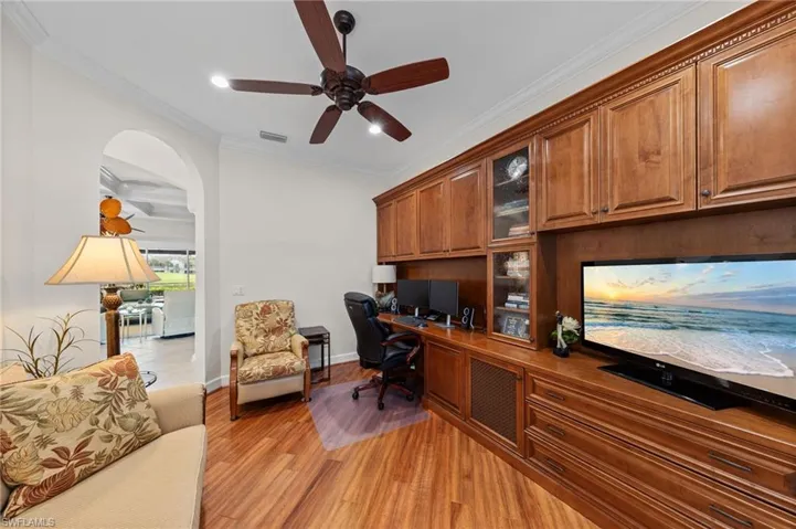 Custom built-in cabinetry with a dedicated desk space, integrated shelving, and media console