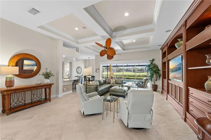 Spacious living area featuring coffered ceilings, recessed lighting, and large format tile flooring