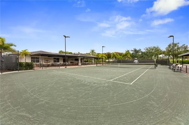 Expansive tennis court with a green playing surface and white line markings