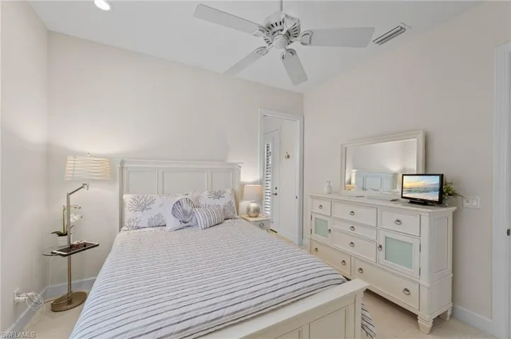 Vaulted ceiling with a ceiling fan, recessed lighting, and light-toned wall finishes