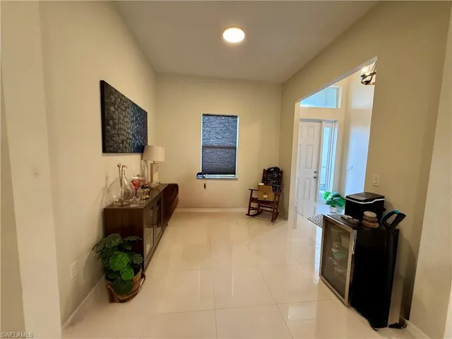 Entrance foyer with baseboards and light tile patterned floors