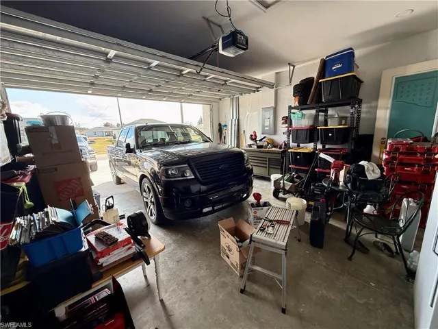 Garage with a garage door opener and electric panel