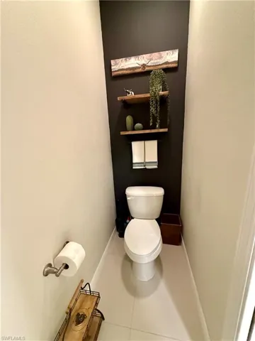 Bathroom featuring toilet and tile patterned flooring