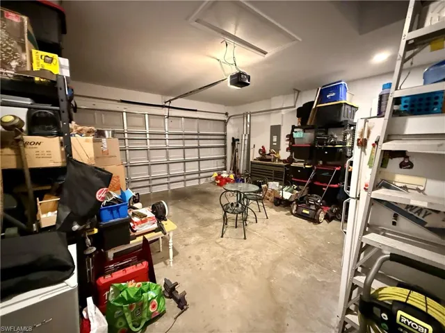 Garage with electric panel and a garage door opener