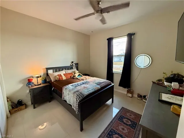 Bedroom featuring ceiling fan and baseboards