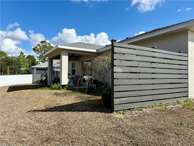 Back of house featuring stucco siding, a patio area, and ceiling fan