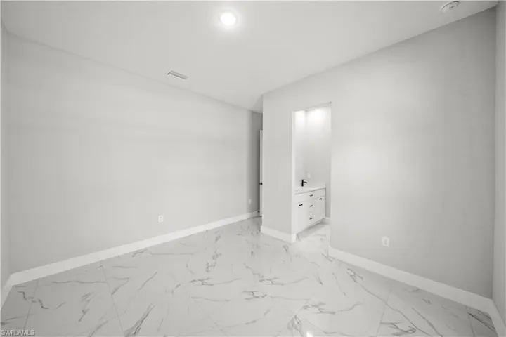 Spare room with marble finish floor, recessed lighting, baseboards, and visible vents