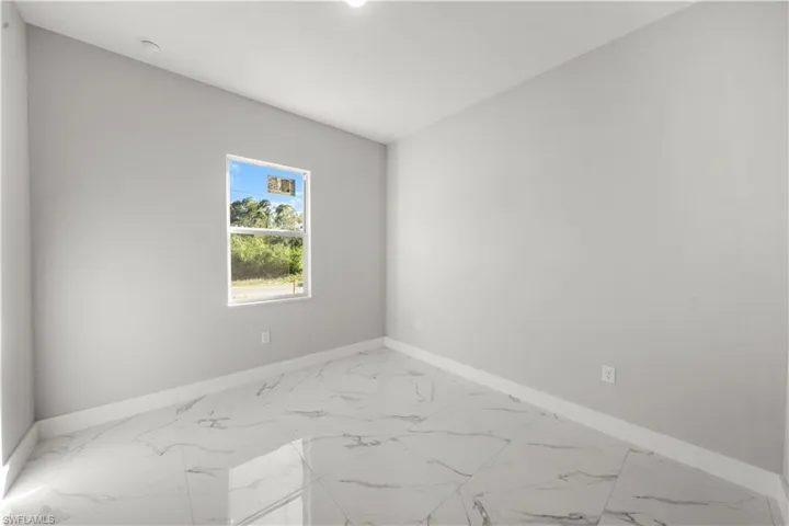 Spare room with baseboards and marble finish floor