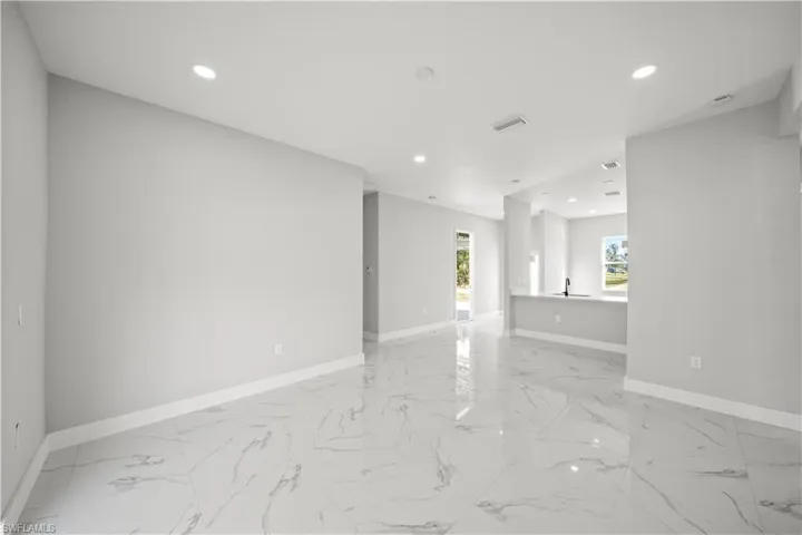 Empty room featuring baseboards, marble finish floor, visible vents, and recessed lighting