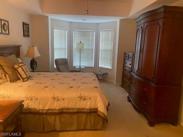 Bedroom featuring light colored carpet