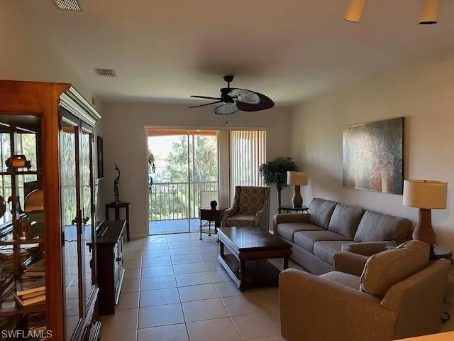 Living room featuring ceiling fan and light tile patterned flooring