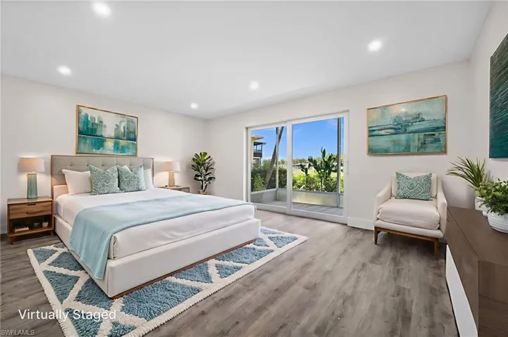Bedroom with access to exterior, recessed lighting, and wood finished floors