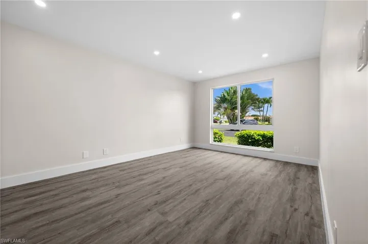 Spare room featuring wood finished floors and recessed lighting