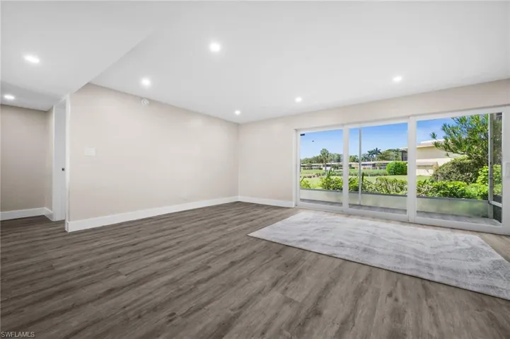 Unfurnished living room featuring recessed lighting and wood finished floors