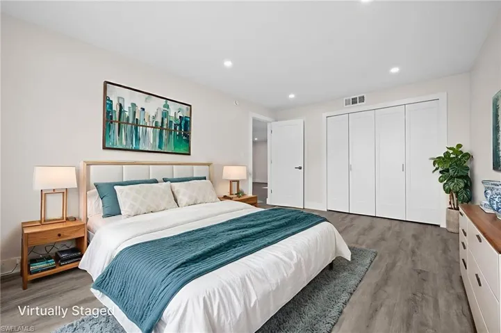 Bedroom featuring wood finished floors, recessed lighting, and a closet