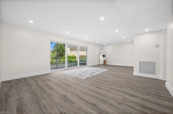 Unfurnished living room featuring recessed lighting and wood finished floors