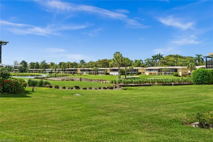 View of green lawn featuring a water view