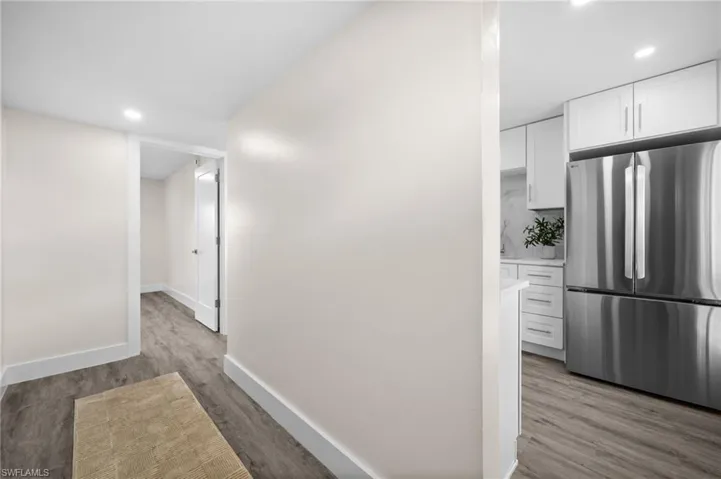 Corridor featuring recessed lighting and light wood-style floors