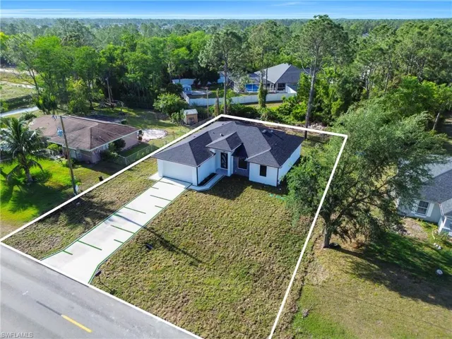 Birds eye view of property featuring a view of trees