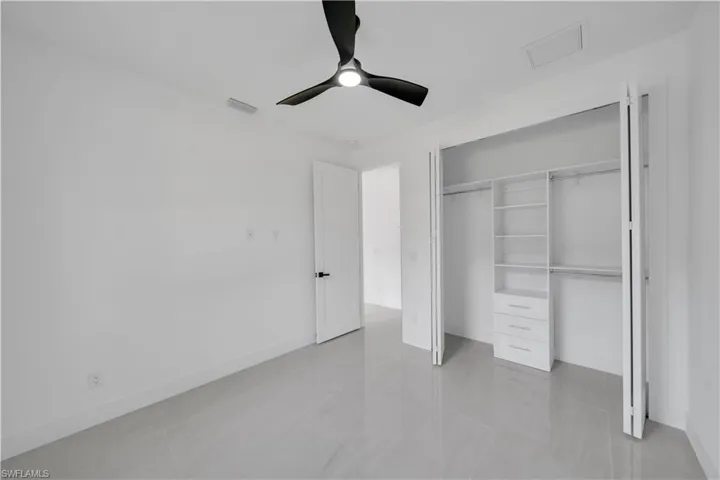Unfurnished bedroom with a ceiling fan, baseboards, a closet, and visible vents