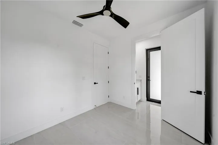 Unfurnished room with baseboards, visible vents, and a ceiling fan
