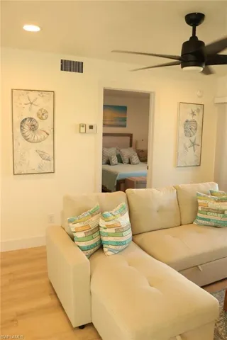Light wood-finish flooring complements the neutral wall color