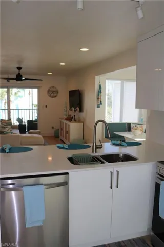Modern kitchen island featuring a double stainless steel sink with a gooseneck faucet
