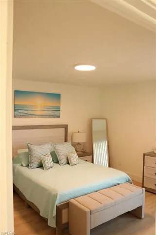 Recessed ceiling light fixture illuminating a room with light wood-finish flooring