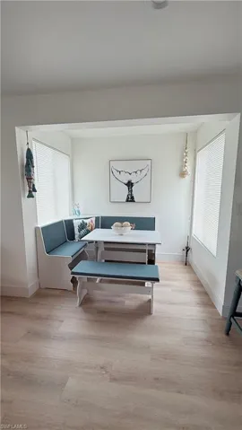 Dining nook with built-in bench seating and two large windows