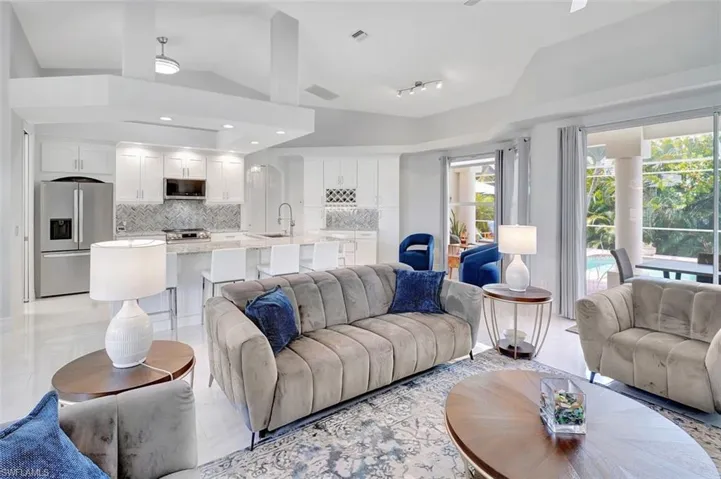 Living room featuring vaulted ceiling and recessed lighting