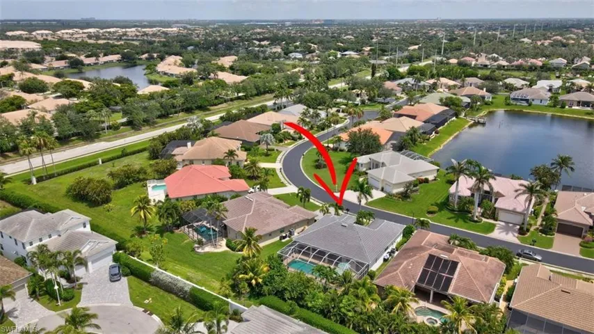 Aerial view of residential area featuring a nearby body of water