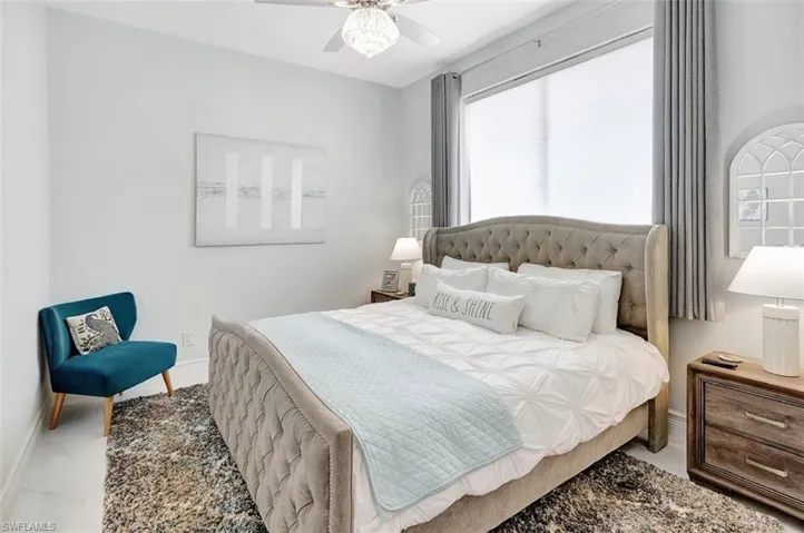 Bedroom featuring marble look tiles and ceiling fan