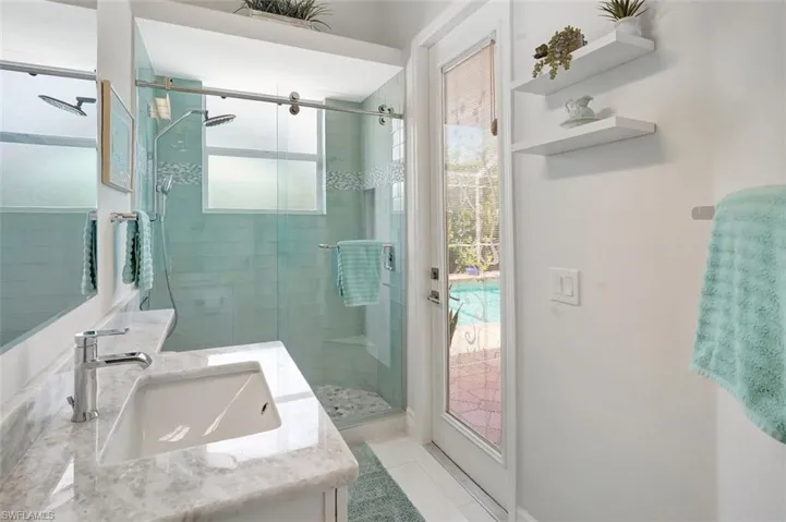 Bathroom featuring vanity, a stall shower, and tile patterned flooring