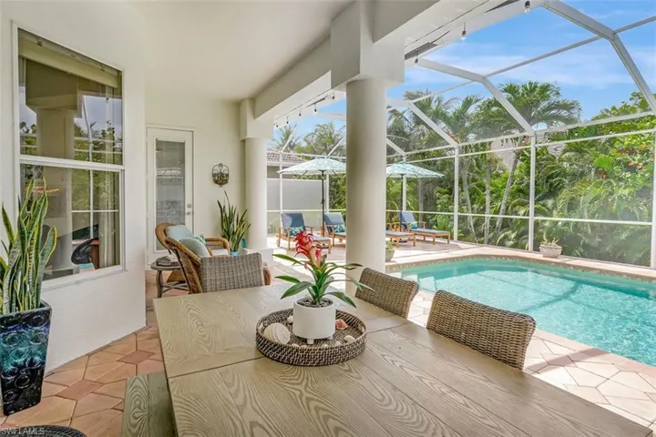 Swimming pool with a patio area and glass enclosure