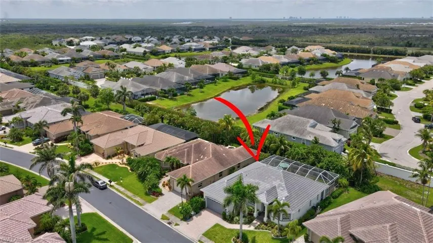 Aerial perspective of suburban area featuring a large body of water