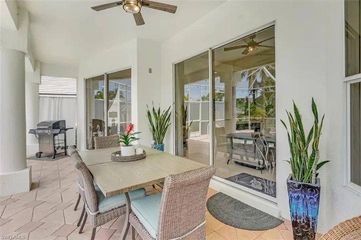 View of patio with a ceiling fan, outdoor dining area, and a grill