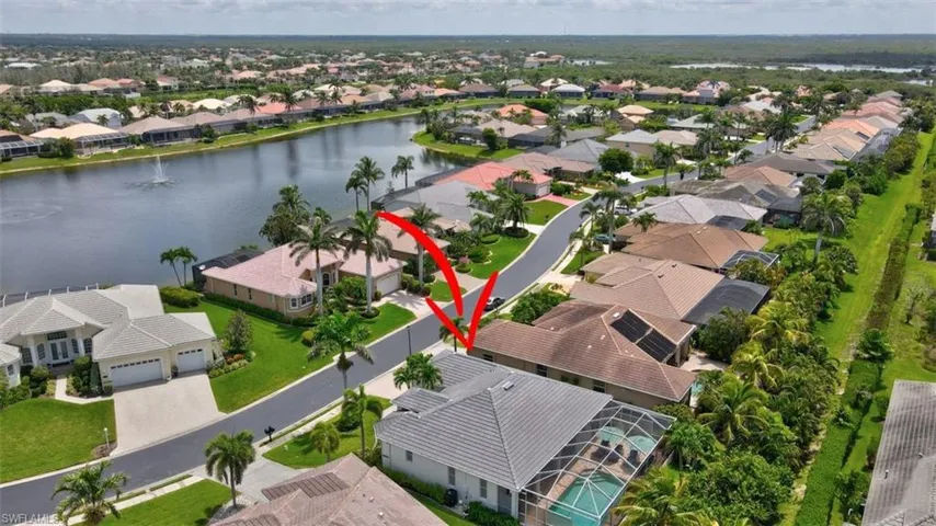 Aerial view of residential area featuring a large body of water