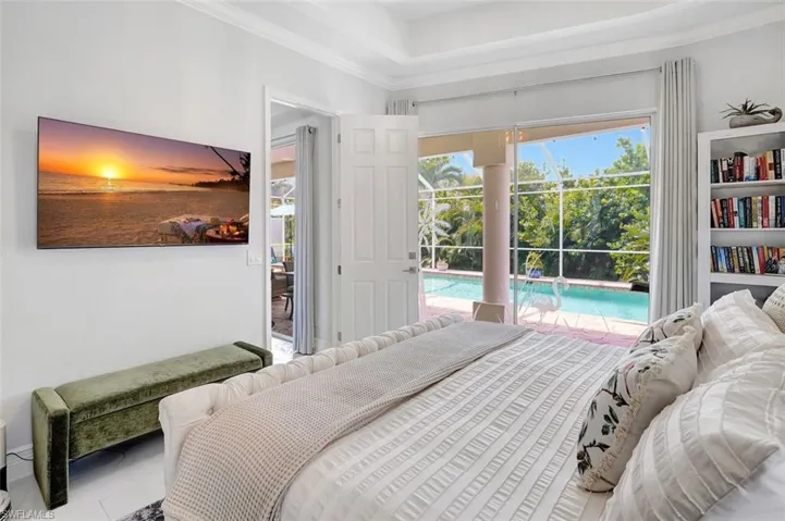 Bedroom with access to outside and crown molding