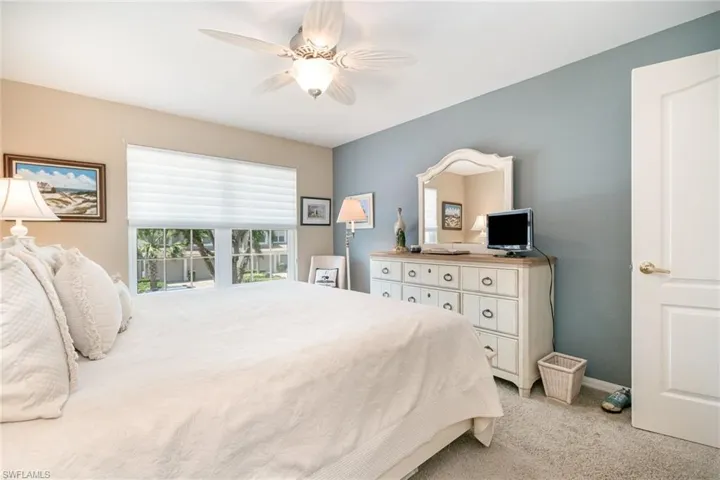 2nd Bedroom featuring light colored carpet, ceiling fan, and baseboards